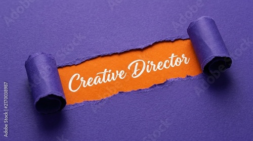 Creative Director Text Revealed Under Torn Purple Paper Background