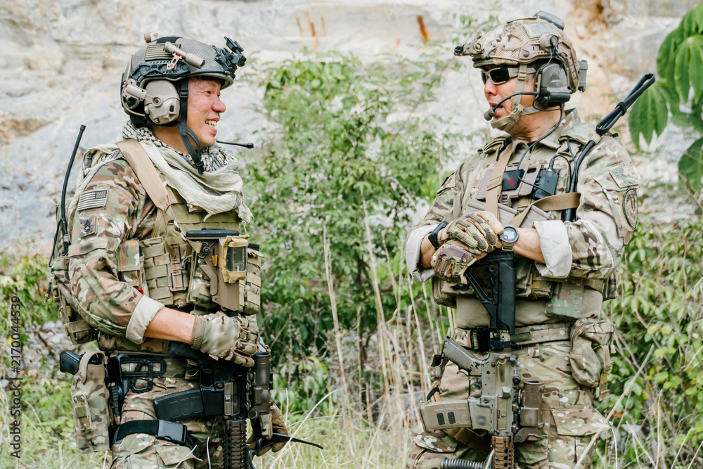 Obraz premium Professional soldiers outdoor jungle soldiers on duty feel confident during friendly conversation in tactical forest training ground