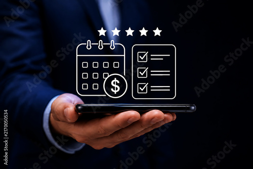 Close up of a businessman holding a smartphone with a floating digital calendar and checklist with a five star rating system above it