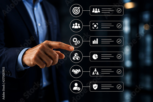 Businessman interacting with a digital interface showing a checklist of business including target, team, gears, cubes, handshake, and shield