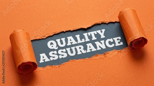 Quality Assurance Text Revealed Under Torn Orange Paper Background