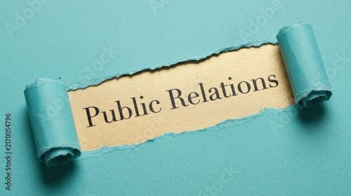 Public Relations Text Revealed Under Torn Blue Paper Background