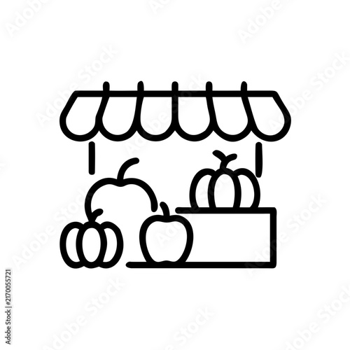 Autumn street market in European city with pumpkins and apples on wooden stalls
