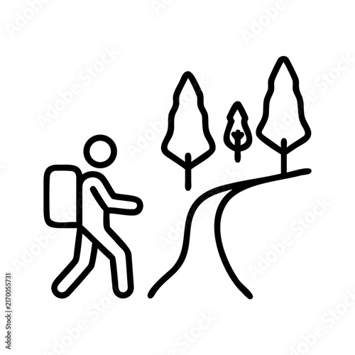 Hiker walking in the autumn, backpack and hiking gear on a path with trees