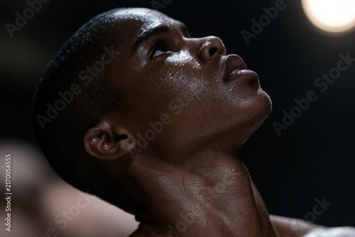 Profile of male dancer with sweat under dramatic stage lighting