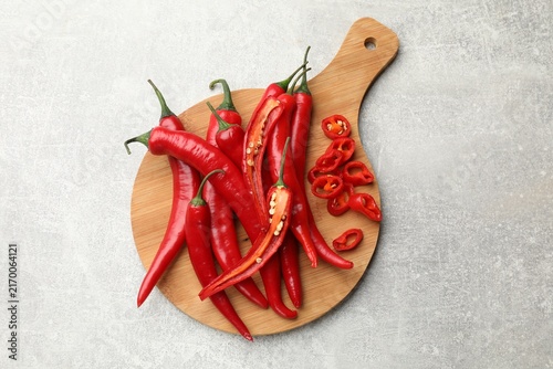Fotografie Aromatic spice. Fresh chili peppers on grey table, top view
