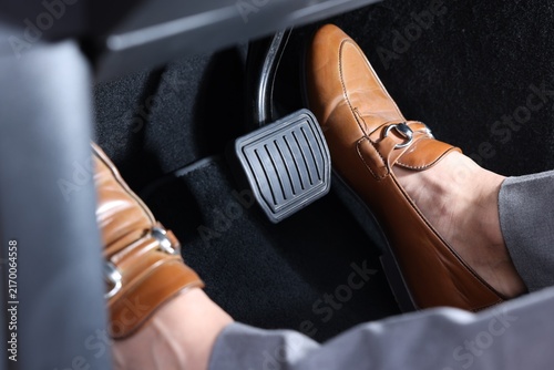 фотографія Woman pushing accelerator pedal in car, closeup on foot