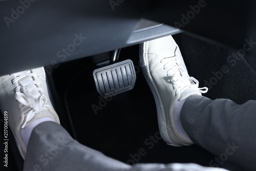 Obraz na płótnie Man pushing accelerator pedal in car, closeup on foot