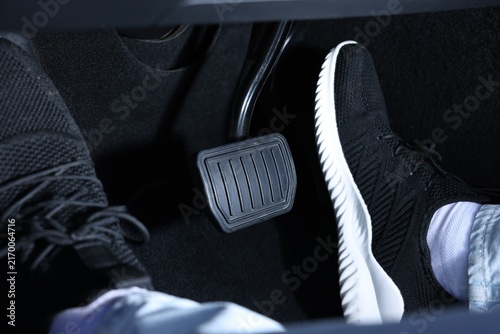 Photography Man pushing accelerator pedal in car, closeup on foot