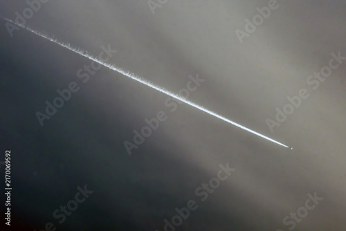 Картината върху платно Airplane in the blue sky with contrail in the air.