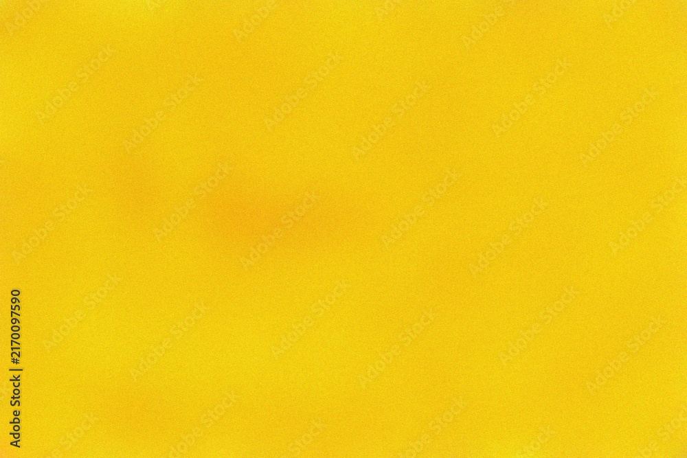 Fototapeta premium Vibrant yellow textured surface with soft grain effect for modern minimalist design projects