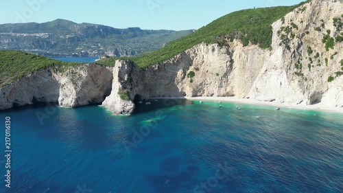Aerial descending shot showing turquoise sea and white cliffs at Chomi Beach in Corfu near Paleokastritsa