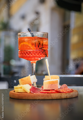Vibrant orange Italian spritz cocktails with a charcuterie board, Sanremo, Italy