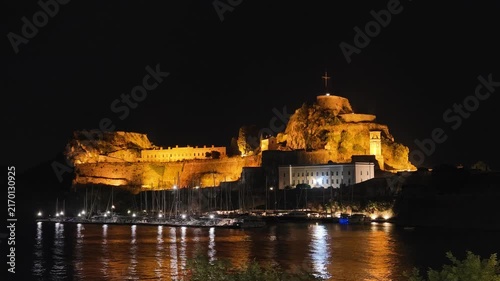 Aerial night view of the Old Fortress illuminated above the marina in Corfu, Greece