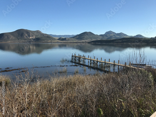 Weathered Wooden Pier Extending Into Calm Morro Bay Estuary