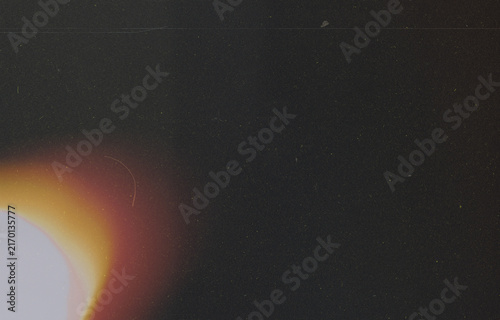 Warm Light Leak on Dark Film Grain Texture Overlay With Dust and Scratches for Vintage Photo Editing