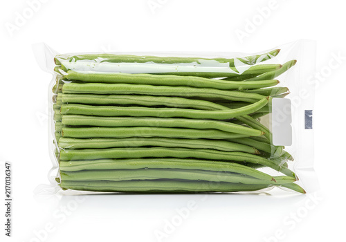 Fresh green long beans packed in transparent plastic wrap isolated on white background.