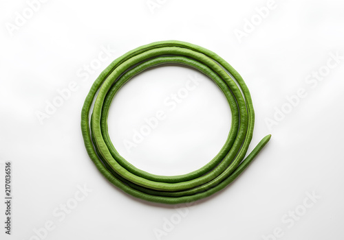 Fresh Yardlong Bean (Kacang Panjang) coiled in a circular shape isolated on a white background