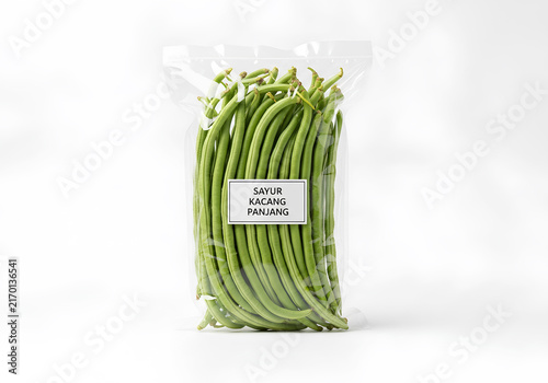 Fresh yardlong beans packaged in a clear plastic bag with a label, isolated on a white background.