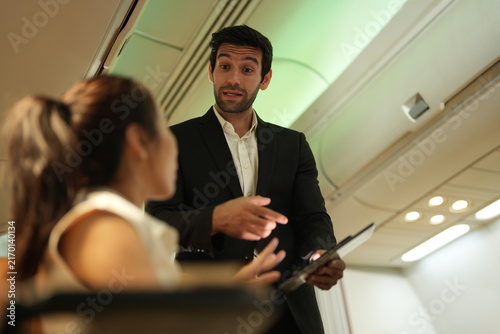 Canvas Print Seatmates on a commercial flight react to something one of them said in the pass