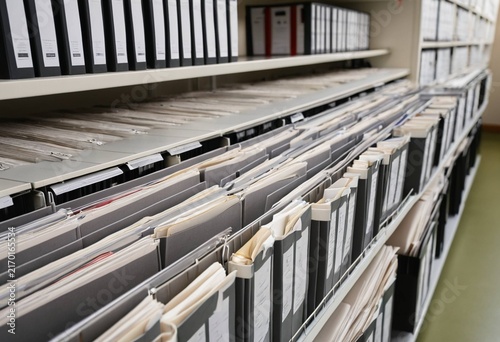 Rows of organized files and binders in a modern archive or office storage room