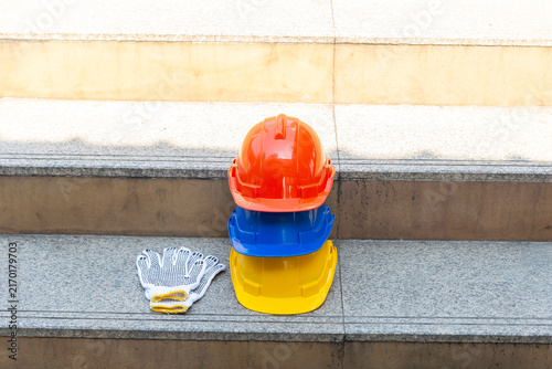 Orange blue white and yellow helmets safety diversity engineering concept
