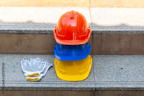 Orange blue white and yellow helmets safety diversity engineering concept