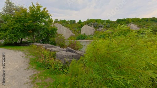 Scarborough Bluffs in the Bluffer's Park, Toronto, Canada. Unrecognizable people on the beach in a distance