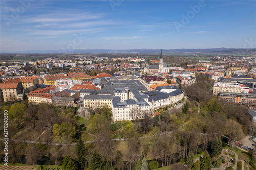 Aerial view of the historic city of Olomouc featuring the Archbishop's Palace and the Cathedral of Saint Wenceslas surrounded by urban architecture and green spaces in Czech Republic.