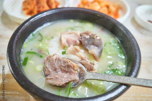 Quadro su tela Hearty traditional Asian beef soup in a black earthen bowl filled with thick meat slices and warm rice