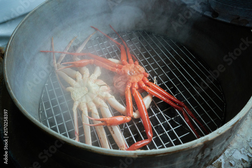 Obraz na płótnie Premium winter crustaceans cooking inside a large traditional metal steamer with rising hot vapor