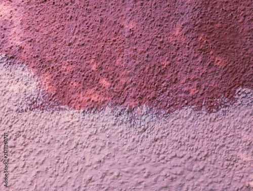 Fotografía Abstract background of a rough textured concrete wall painted in two shades of pink, featuring a dark magenta upper section and a light pastel pink lower section with a horizontal dividing line