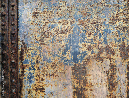 Konstfotografi Heavily rusted industrial metal plate texture with blue paint remnants and rivet