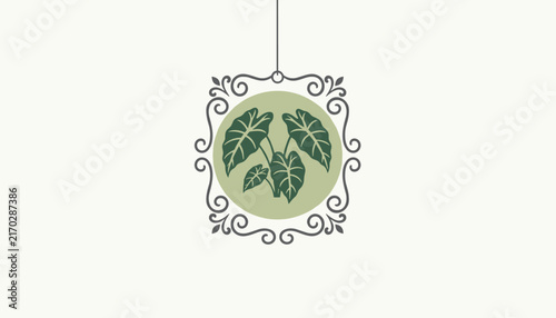 Ornate vintage frame hangs from a string enclosing a lush green alocasia plant with large leaves on a beige field.