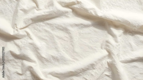 Neutral cotton backdrop featuring irregular creases and highlights