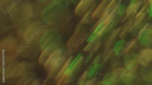 Sparkling glare art. Blurred gleam. Duplicated lens flare prism stroboscopic color rotation. Shiny bokeh light leak green yellow abstract background.