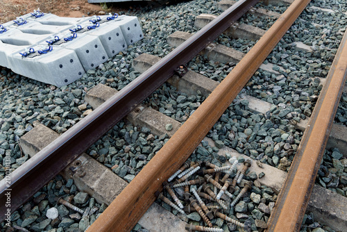 Railroad track with new concrete sleepers and rails ready for installation, representing infrastructure development and transport