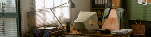 Header of empty retro office workspace featuring vintage computer monitor on wooden desk with turntable and office supplies. Ideal for nostalgic corporate marketing and business history campaigns