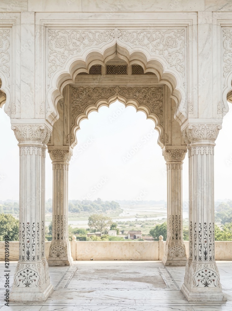 Fototapeta premium Intricate White Marble Arches and Pillars of Mughal Architecture Overlooking a Scenic River Landscape in India