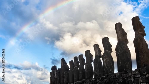 View of the iconic Moai statues at Ahu Tongariki standing in a row against a twilight sky on Easter Island, Valparaiso, Chile.