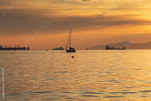 A Sunset view from Sunset Beach, Vancouver, British Columbia. Showing boats and ships in English Bay 