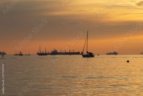 A Sunset view from Sunset Beach, Vancouver, British Columbia. Showing boats and ships in English Bay 