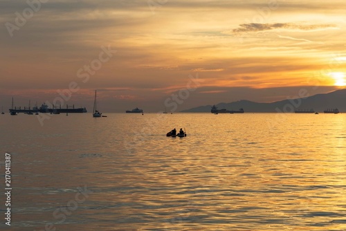 A Sunset view from Sunset Beach, Vancouver, British Columbia. Showing boats and ships in English Bay 