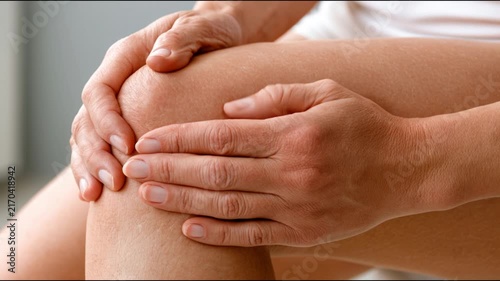 Woman holding painful knee suffering from joint injury and arthritis