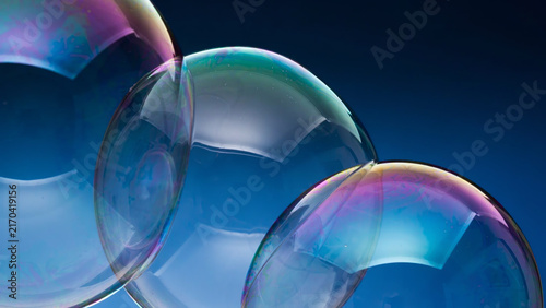 Canvastavla Iridescent soap bubbles floating against deep blue background display colorful light interference patterns