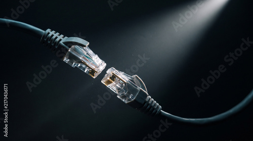 Two translucent RJ45 ethernet network connectors facing each other with internal wires.