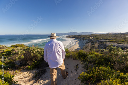 adult man wearing hat exploring beautiful Walker Bay Nature Reserve, Gansbaai, South Africa