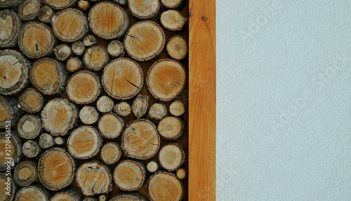 Decorative wall panel made from round pine logs with empty space at a side of image
