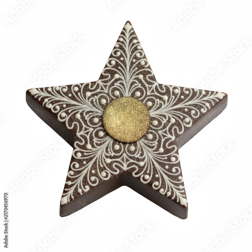 Decorative brown star shaped chocolate cookie with white icing patterns and a gold center for holiday treats