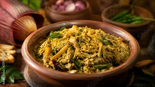 Traditional Sri Lankan banana blossom curry served in clay bowl with coconut milk and spices, authentic village cuisine representing vegetarian food culture, healthy plant-based meal and culinary heri